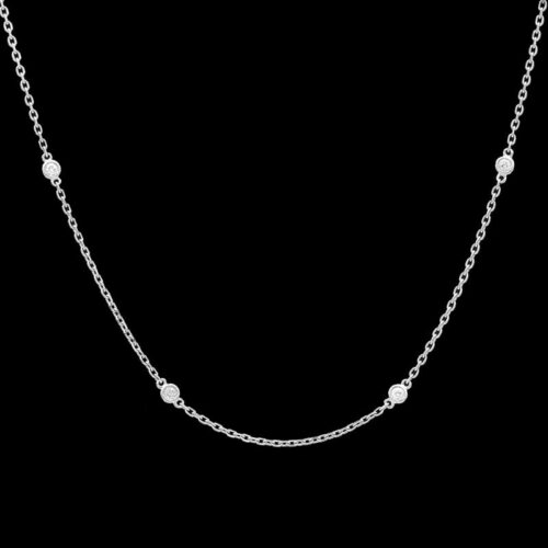 a silver chain necklace with white stones on it