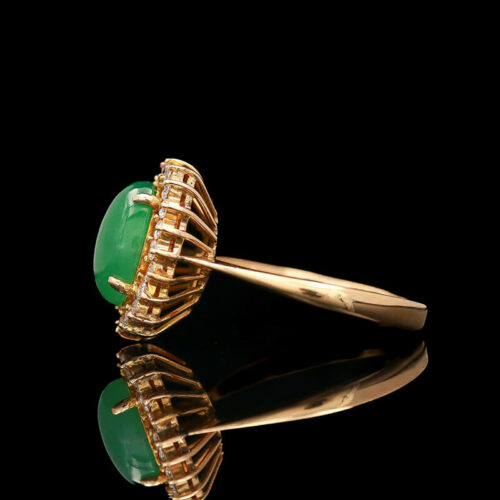a gold ring with a green stone on it
