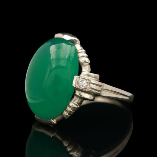 an oval green jade and diamond ring