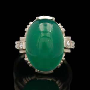 an oval green jade and diamond ring