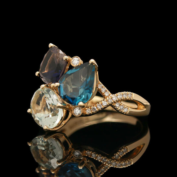 a ring with three stones and diamonds