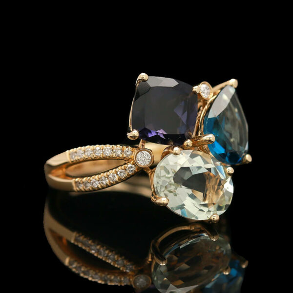 three stone ring with diamonds and blue topaz