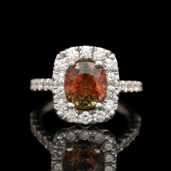 a fancy ring with an orange diamond surrounded by white diamonds