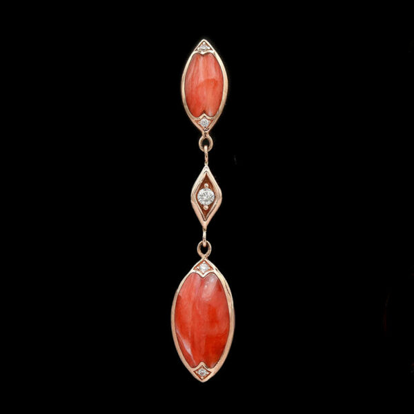 a pair of coral and diamond earrings
