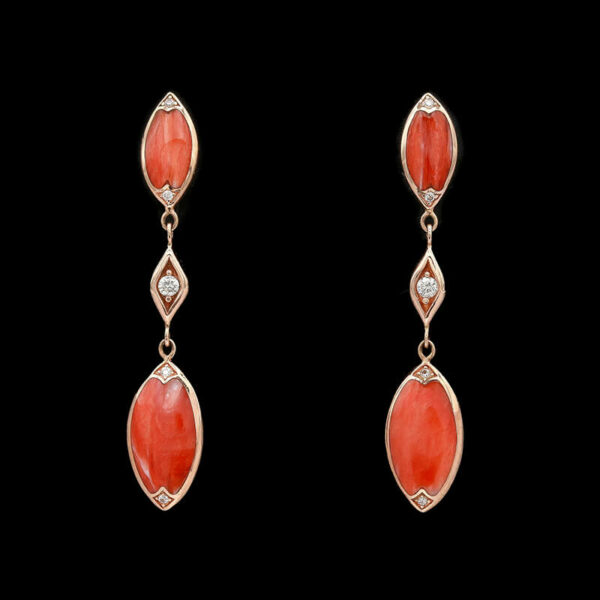 a pair of coral and diamond earrings