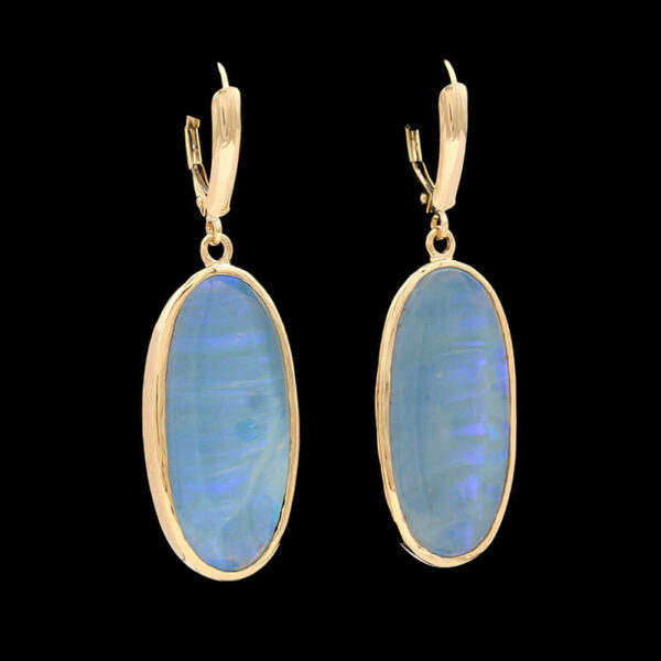 a pair of earrings in yellow gold with blue opal