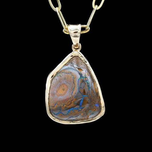 a pendant with a large stone in it