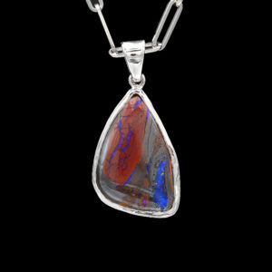 a pendant with a red and blue stone in it