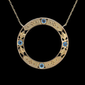 a gold necklace with blue stones on it