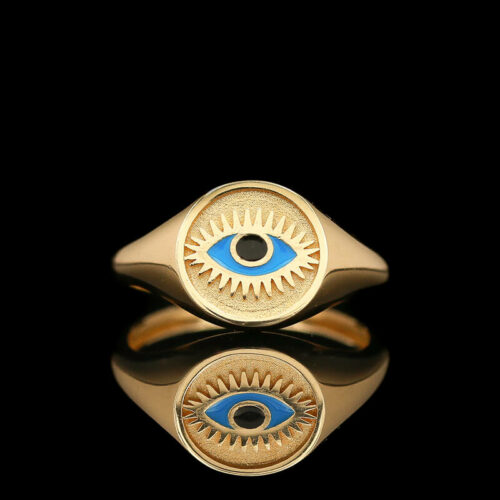 a gold ring with an evil eye on it