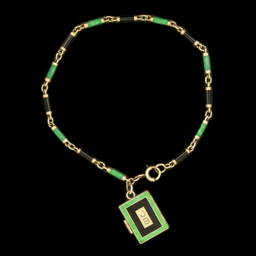 a green and gold necklace with a tag on it