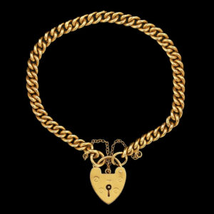 a gold chain bracelet with a heart lock