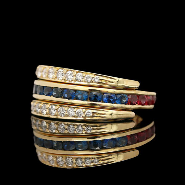 a gold ring with multi - colored stones on it