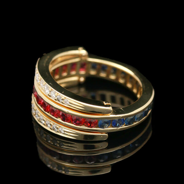 a gold ring with red, blue and white stones
