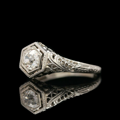 an antique style diamond ring with filigrees
