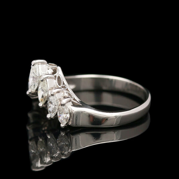 a three stone diamond ring on a black background