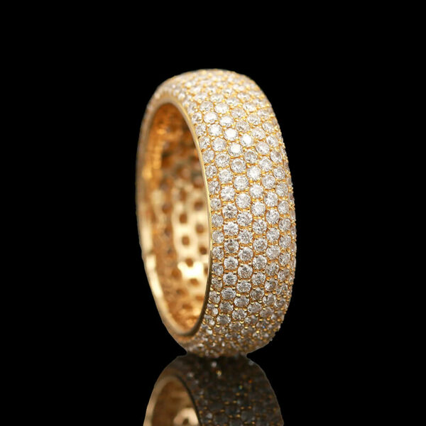 a gold ring with white diamonds on it