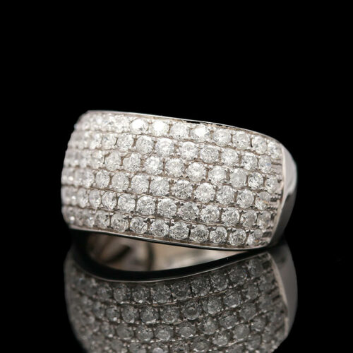 a diamond ring sitting on top of a reflective surface