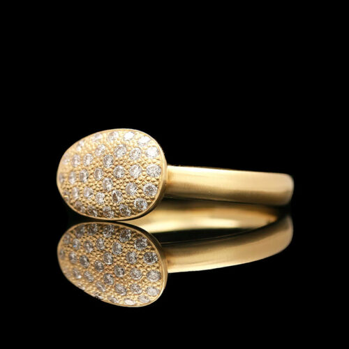 two gold rings with white diamonds on black background