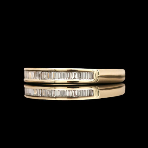 two gold wedding bands with baguetts on each side