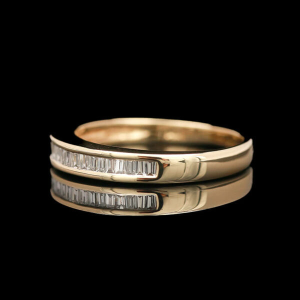 two gold rings with white diamonds on black background