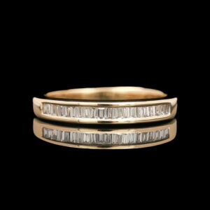 two gold wedding bands with baguettes on each side