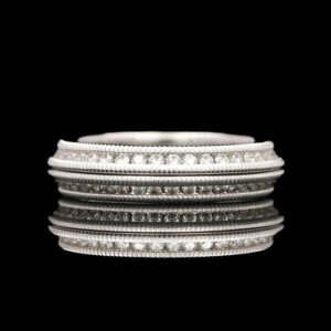 a stack of silver rings on a black background