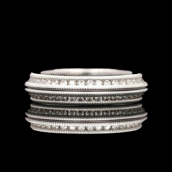 a stack of silver rings on a black background