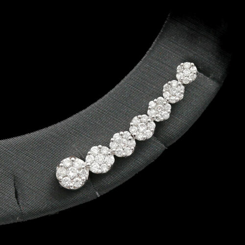 a close up of a brooch with diamonds