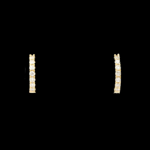 a pair of gold earrings with small diamonds