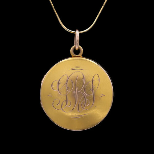 a gold pendant with the word monogram on it