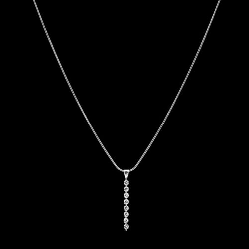 a white gold necklace with diamonds on a black background