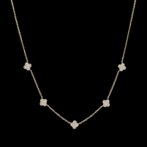 a gold necklace with four white flowers