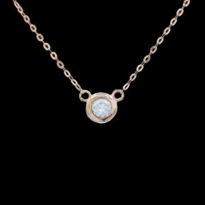 a necklace with a white stone on it