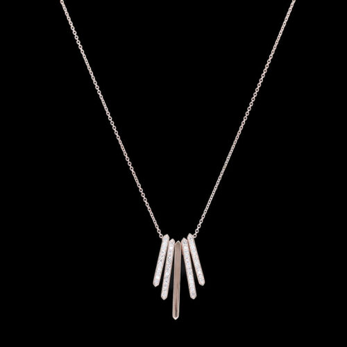 a white necklace with three long bars hanging from it