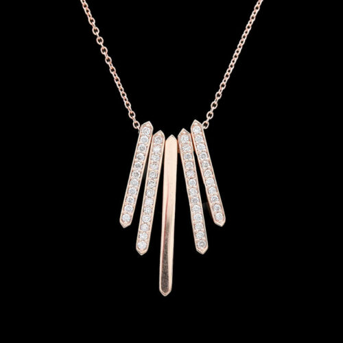 a gold necklace with three diamonds hanging from it