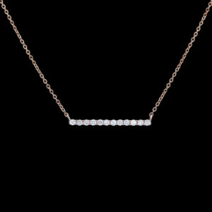 a diamond bar necklace on a black background