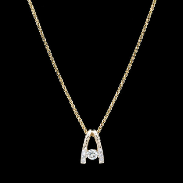a diamond initial necklace on a gold chain