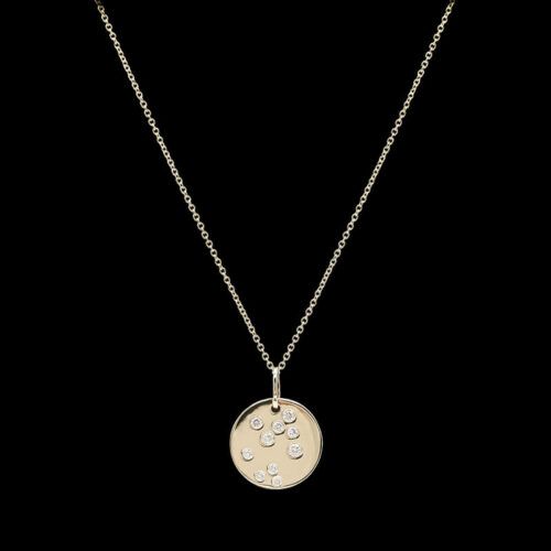 a gold necklace with diamonds on a black background
