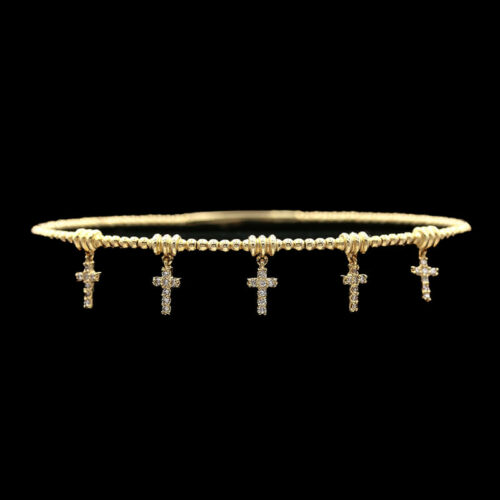 a gold bracelet with three crosses on it
