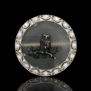 an antique brooch with a horse on it