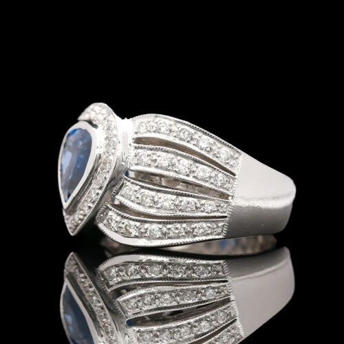 a white gold ring with blue stone and diamonds