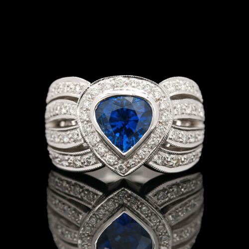a ring with a blue heart surrounded by diamonds