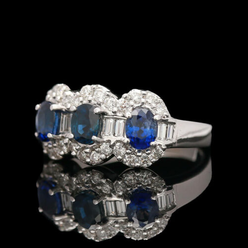 a three stone ring with blue sapphires and diamonds