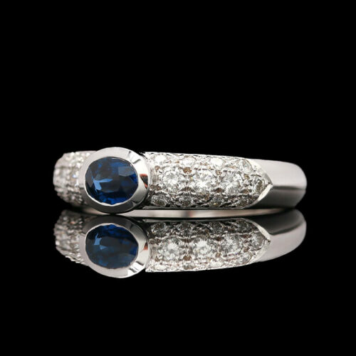 a blue sapphire and diamond ring on a black background