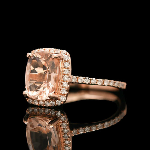 an engagement ring with a cushion cut peach morganite surrounded by diamonds