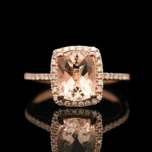 an engagement ring with a cushion cut peach morganite surrounded by diamonds