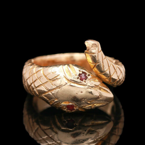 two gold rings with garnets on them