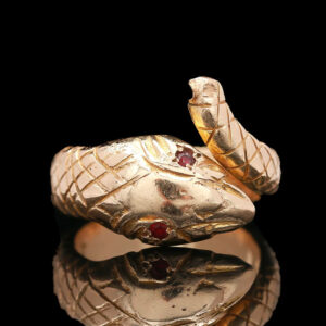 a close up of a gold ring with a snake on it