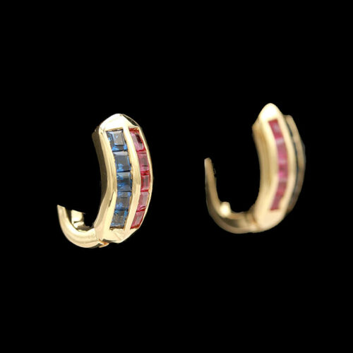 a pair of gold earrings with red, white and blue stones
